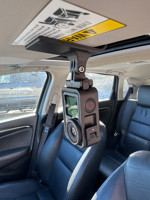 RACE MOUNTS sun visor camera mount installed with a DJI action camera